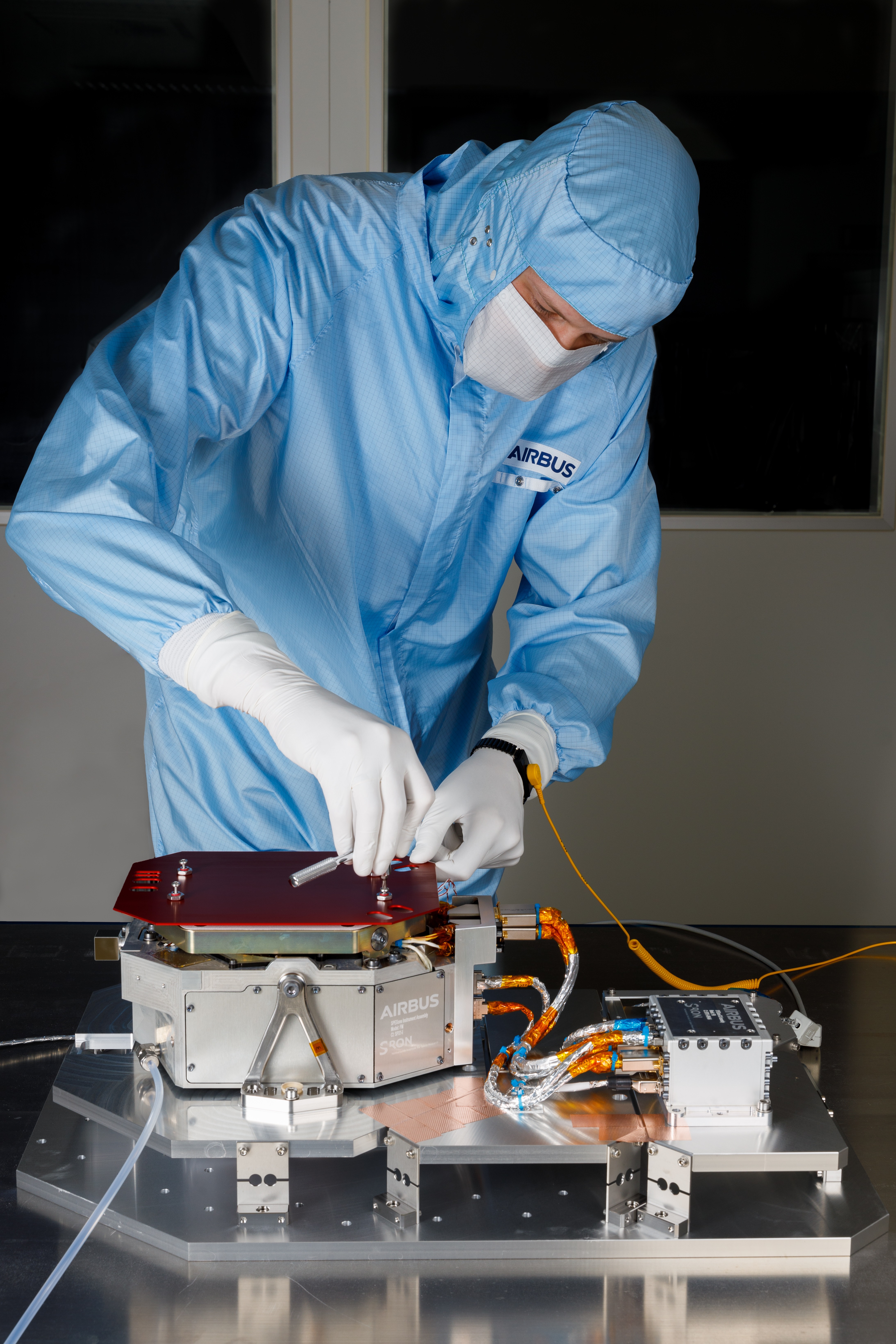 A technician prepares the SPEXone flight instrument for vibration testing.