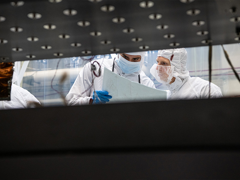 A mechanical engineer reviews integration documentation with the QA Engineer.