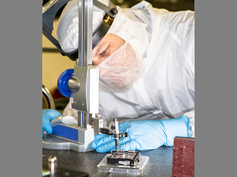NASA Technician Andrew Scharmann verifies correct spring deflection