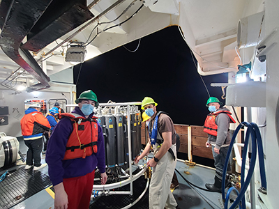 Crew members aboard a CalCOFI cruise wear masks during sampling operations due to smoke from the January 2025 LA County wildfire