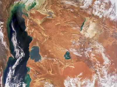 On the left of this image is the world’s largest inland body of water, the Caspian Sea. Green colors are likely the result of phytoplankton blooms. At top right is a narrow body of water with a patch of beige to its east. This is the Aral Sea, which was once the fourth largest lake in the world. In the 1960s, however, the Soviet Union diverted its water to irrigate crops. For decades, airborne particles, known as aerosols, have blown from the exposed lakebed. Credit: NASA