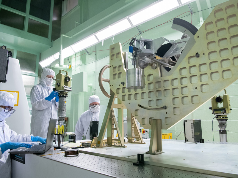 The optical alignment team performs gravity sag measurements on the Ocean Color Instrument Main Optics Sub Bench (MOSB). Credit: Stover, Desiree