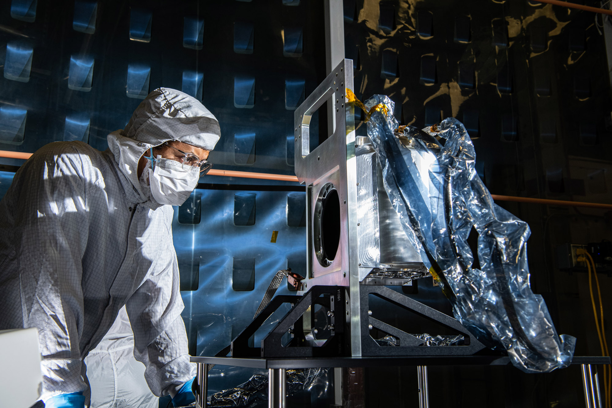 Aerospace Engineer, Daniel Senai, inspects the completed Ocean Color Instrument Solar Calibration Assembly (SCA) Life Test Unit mechanism.