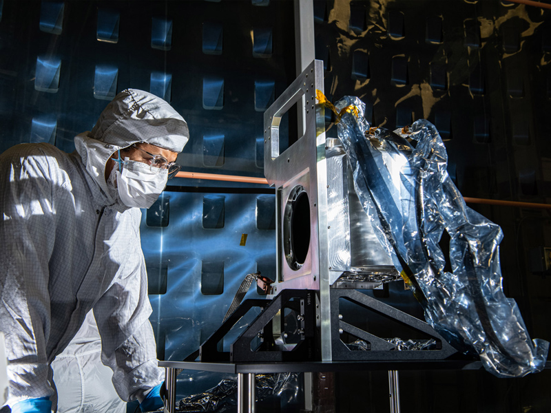 Aerospace Engineer, Daniel Senai, inspects the completed Ocean Color Instrument Solar Calibration Assembly (SCA) Life Test Unit mechanism. Credit: Henry, Dennis (Denny)