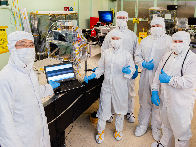 The Ocean Color Instrument Optical Alignment team poses for a group photo after successful alignment of the flight Main Optics Bench and Rotating Telescope assembly. Credit: Guinto, Michael