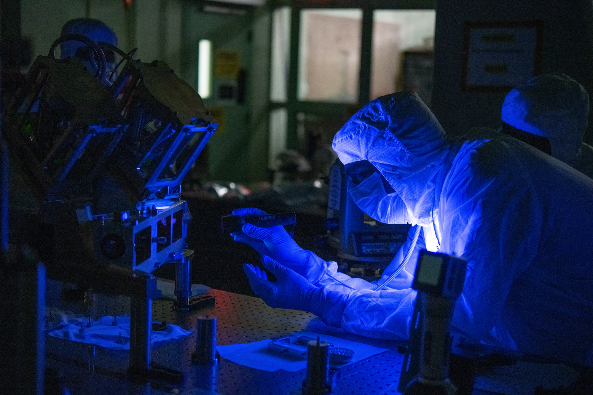 Optical engineer, David Kubalak, inspects the Ocean Color Instrument Main Optics Sub Bench (MOSB) interior optics prior to covers are installed.