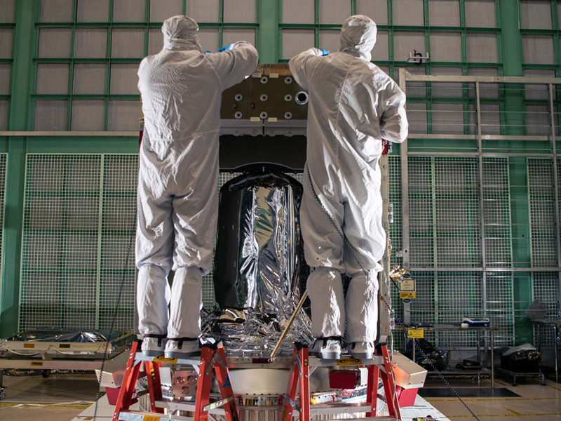 Assembling PACE spacecraft bus structure. Propulsion tank is in the middle of the photo.
