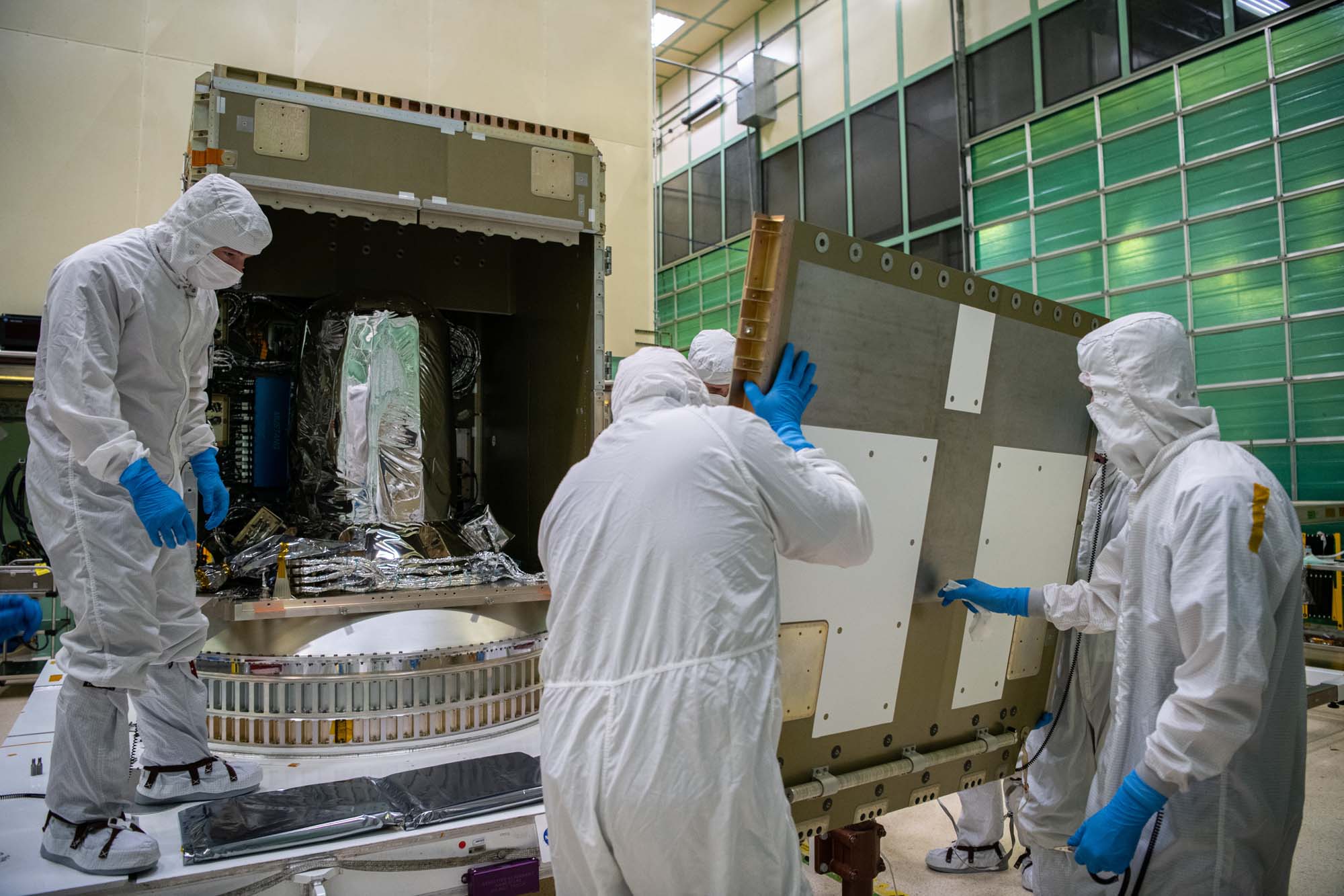 Panel (-Y) being installed on the spacecraft structure.