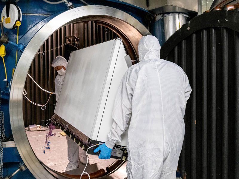 Mechanical Technicians Daniel Dizon and Joseph Eddy transport the Ocean Color Instrument Earth Shade into the thermal vacuum chamber. Credit: Mellos, Katherine