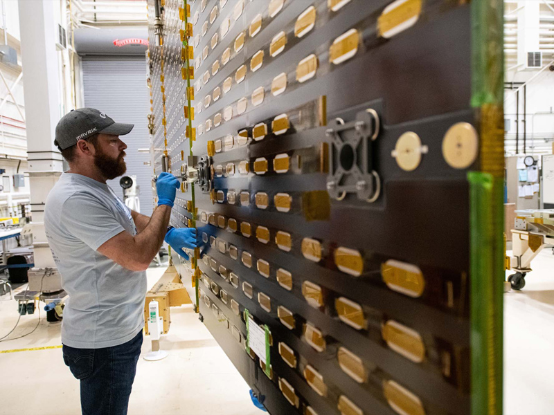 Tightening bolts on the PACE engineering test unit solar array drive assemblies wing setup.
