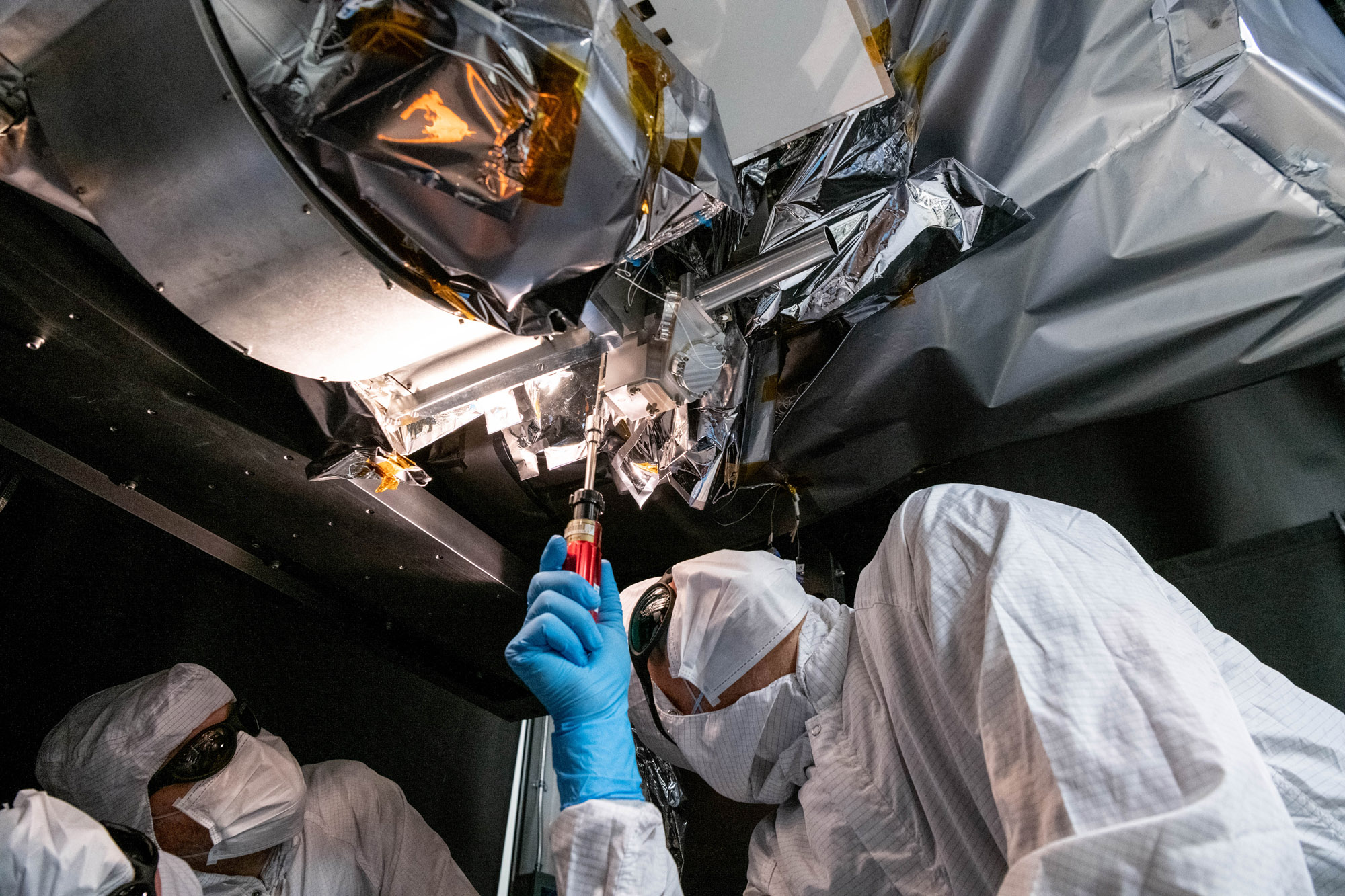 Mechanical technician, Thomas Huber, integrates the Short Wave Infrared (SWIR) Pulse Calibration Assembly (SPCA) fold mirror assembly to the Ocean Color Instrument.