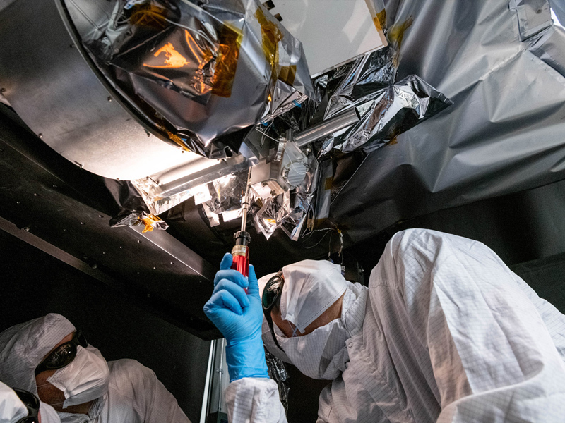Mechanical technician, Thomas Huber, integrates the Short Wave Infrared (SWIR) Pulse Calibration Assembly (SPCA) fold mirror assembly to the Ocean Color Instrument. Credit: Mellos, Katherine