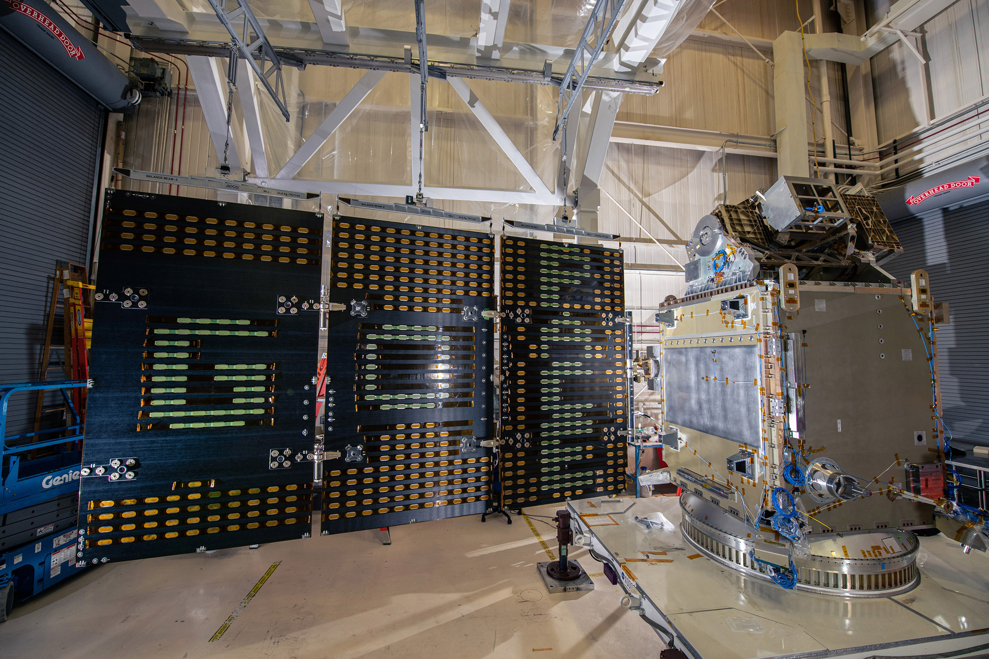 Aligning the solar arrays and Structural Verification Unit to perform electrical tests.