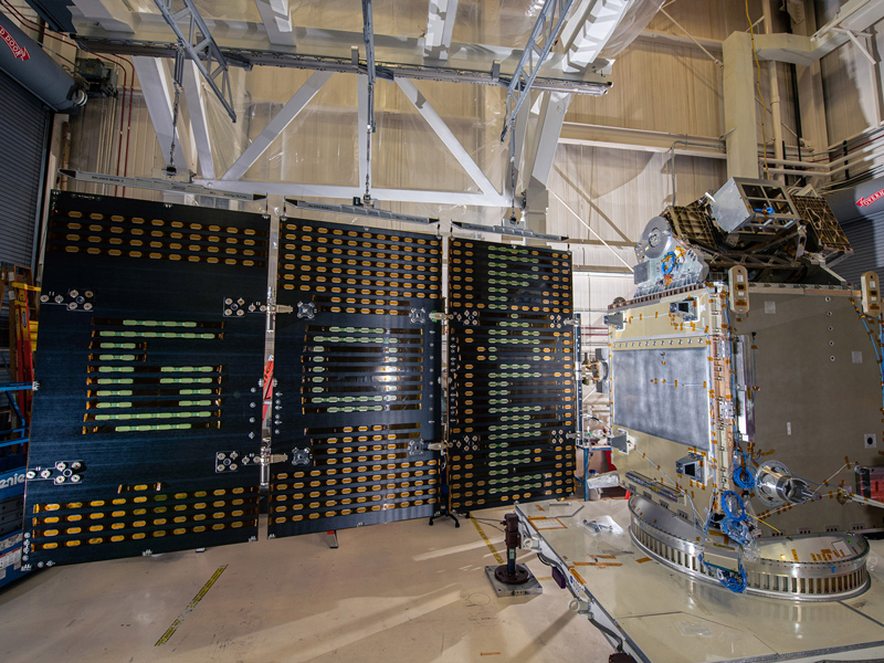 Aligning the solar arrays and Structural Verification Unit to perform electrical tests.