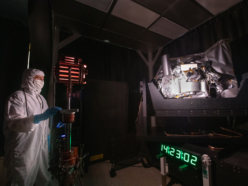 Systems engineer, Joseph Knuble, adjusts the intensity of the studio lamp during the Ocean Color Instrument stray light testing. Credit: Stover, Desiree