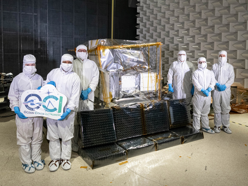 The Ocean Color Instrument Electro-Magnetic Interference (EMI) Team pose in the EMI cleanroom at Goddard Space Flight Center. Credit: Mellos, Katherine