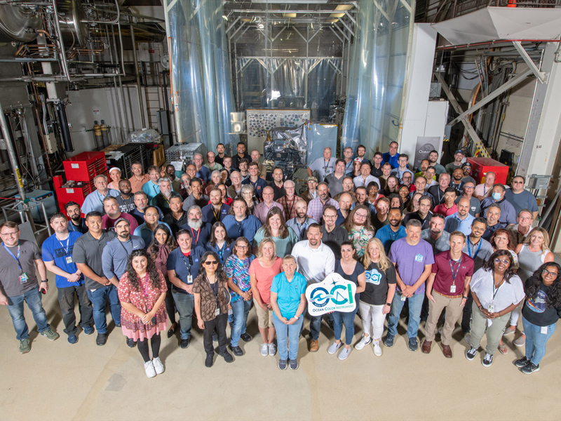 The Ocean Color Instrument (OCI) team poses with OCI and its integrated Earth Shade in June 2022 at Goddard Space Flight Center. Credit: Stover, Desiree
