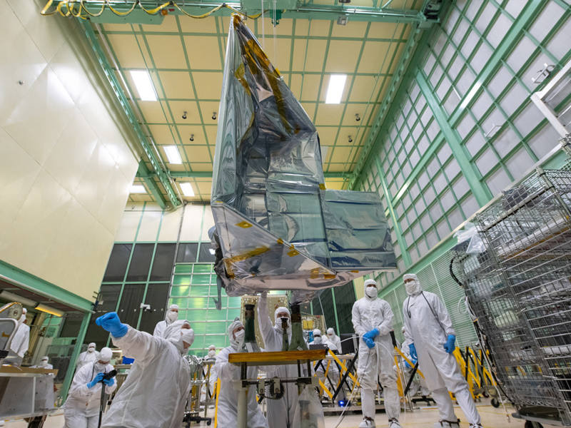 Mechanical technicians crane lift the Ocean Color Instrument with Earth Shade onto the Flight Tilt Mechanism. Credit: Stover, Desiree