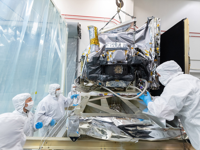 Mechanical technicians crane lift the Ocean Color Instrument on to the Thermal Vacuum Chamber (TVAC) cart. Credit: Stover, Desiree