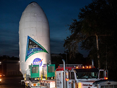 NASA’s PACE spacecraft encapsulated inside SpaceX’s Falcon 9 payload fairings is transported from the Astrotech Space Operations Facility on Thursday, Feb. 1, 2024, to be mated with a SpaceX Falcon 9 in preparation for liftoff. Credit: NASA