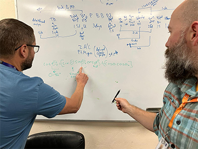 Kerry Meyer (NASA GSFC, left) and Sam LeBlanc (NASA Ames, right) discuss satellite and aircraft geometry at the NASA Armstrong Flight Research Center in Lancaster, CA