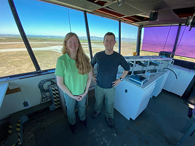 Carolyn Jordan (LaRC) and Michael Shook (LaRC) setting up the LARGE instrument in the tower at the Marina Municipal Airport.