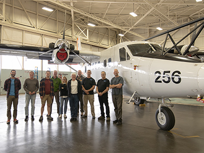 PACE-PAX Marina team photo with the Twin Otter. From left to right: Adam Ahern (NOAA CSL), Anthony Bucholtz (NPS), Michael Shook (NASA LaRC), Brian Cairns (NASA GISS), Francesca Gallo (NASA LaRC), Eddie Winstead (NASA LaRC), Jeff Martin (NPS), Bryce Kujat (NPS), Roy Woods (NPS), Greg Cooper (NPS).