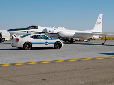 The NASA ER-2, and its support chase car, during post-flight checks at the NASA Armstrong Flight Research Center in Lancaster, CA.     