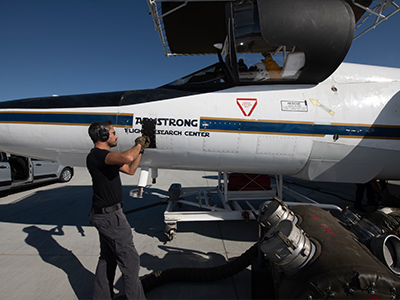 ER-2 mechanic Darick Alvarez closes a panel during ER-2 flight preparations at the NASA Armstrong Flight Research Center in Lancaster, CA. 