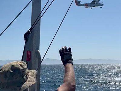 The Naval Postgraduate School (NPS) CIRPAS Twin Otter doing a low altitude flyby of the NOAA R/V Shearwater on September 6th, 2024. In the foreground is R/V Shearwater platform scientist Michael Ondrusek (NOAA).