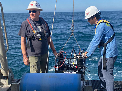 Scott Freeman and Harrison Smith (NASA GSFC) deploy ocean scientific instruments from the R/V Shearwater in the Santa Barbara Channel.