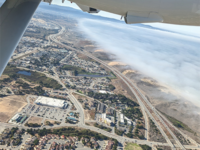 Coastal marine stratocumulus clouds over the Monterey Bay, with a sunny view inland near Marina, California. Taken from the Navy Postgraduate School (NPS) CIRPAS Twin Otter.