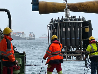 Scientists on the RRS <em>James Cook</em> deploy a sampling rosette. This type of platform allows for the collection of water samples and other information from ocean depths. The RRS <em>Discovery</em> and R/V <em>Sarmiento de Gamboa</em> can be seen  in the distance deploying the same instrumentation. Credit: Deborah Steinberg