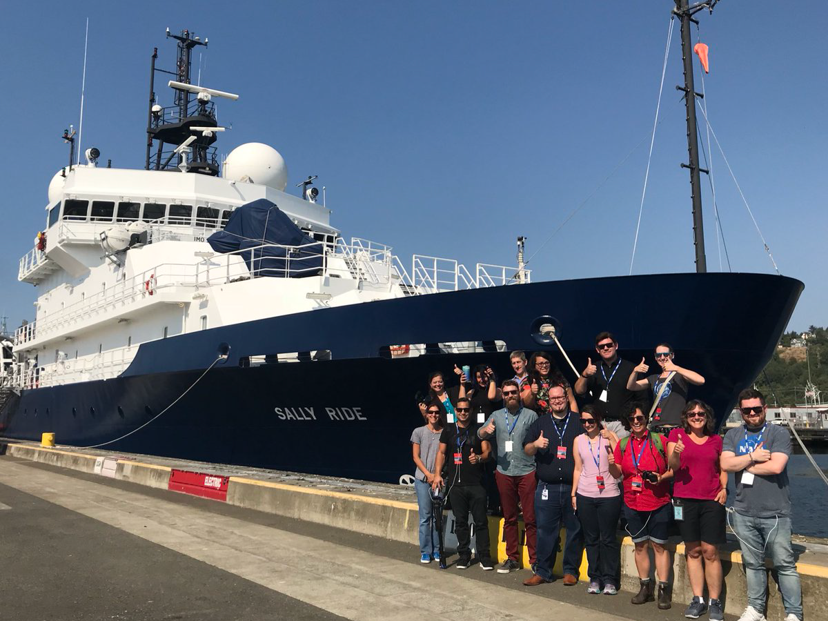 Participants from a NASA social media event pose by the R/V Sally Ride