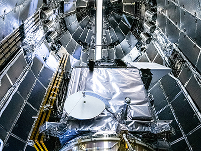 NASA and SpaceX technicians safely encapsulate NASA’s PACE spacecraft in SpaceX’s Falcon 9 payload fairings. Credit: NASA