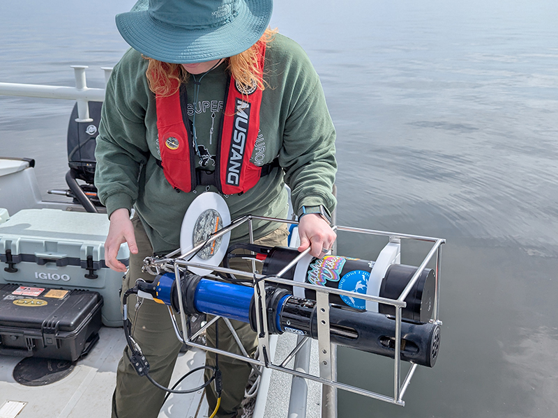 Kendra Herweck deploying a Sequoia hyper-bb, YSI EXO2 sonde, and secchi disk