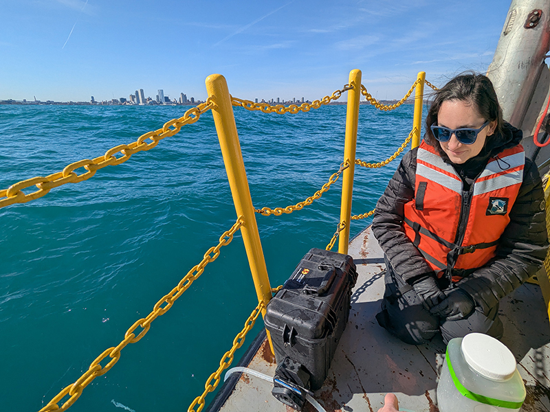 Emily Hyland collecting water samples off the R/V Neeskay in Lake Michigan