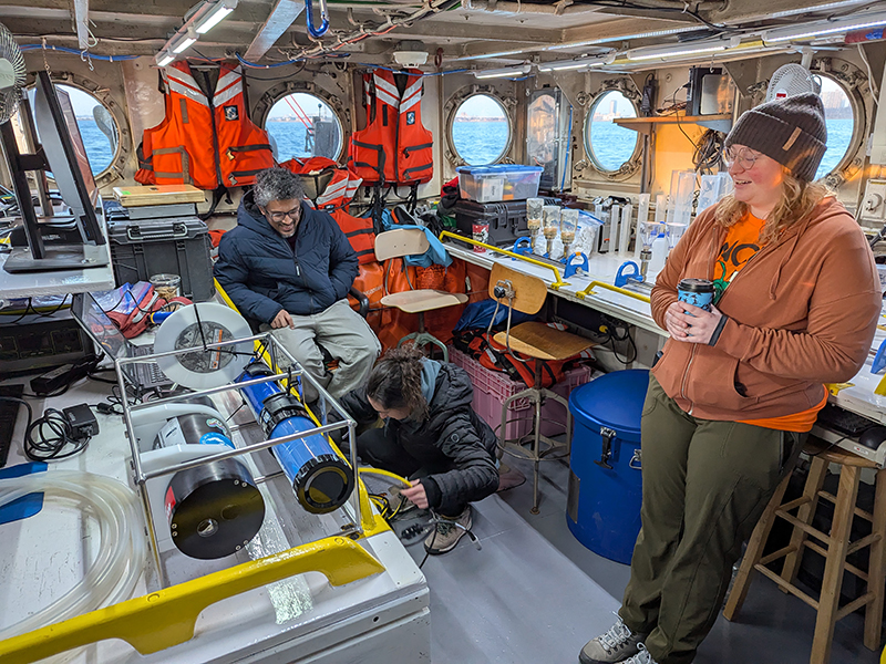 Kendra Herweck, Emily Hyland, and Wahid Khan inside the wet lab on the R/V Neeskay, prepping for a day of sampling Lake Michigan