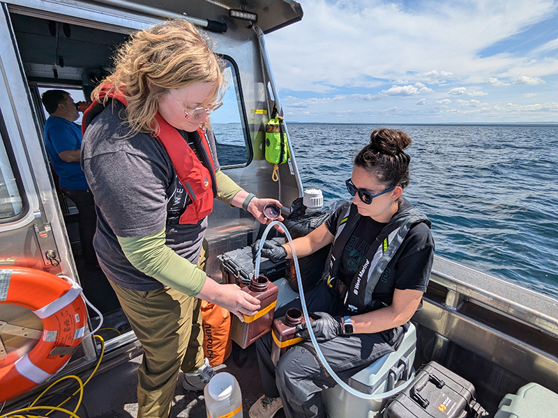 Kendra Herweck and Emily Hyland collecting water samples in Lake Superior on the R/V Soliton
