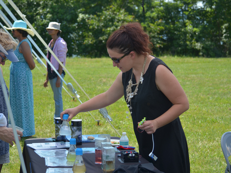 Dr. Ivona Cetini? (right) shows participants at the annual sneaker depth measurement event information about ocean color. Credit: NASA GSFC