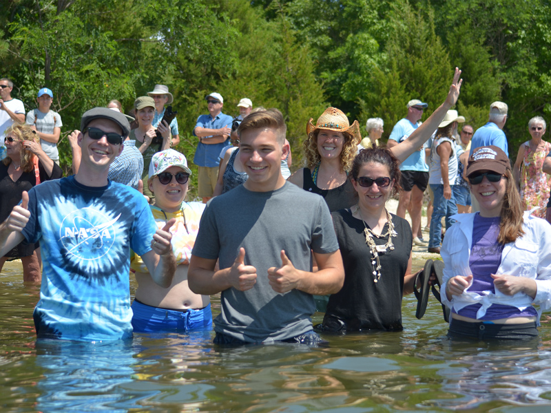 Ben Crooke (center), a 17-year-old NASA summer intern, helped derive Fowler’s Sneaker Depth. Crooke spent part of his summer analyzing Fowler’s data and satellite imagery to understand local trends in water clarity. Credit: NASA GSFC